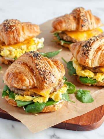 Baked Croissant Breakfast Sandwich with Sausage, Spinach, and Melted Cheese Recipe