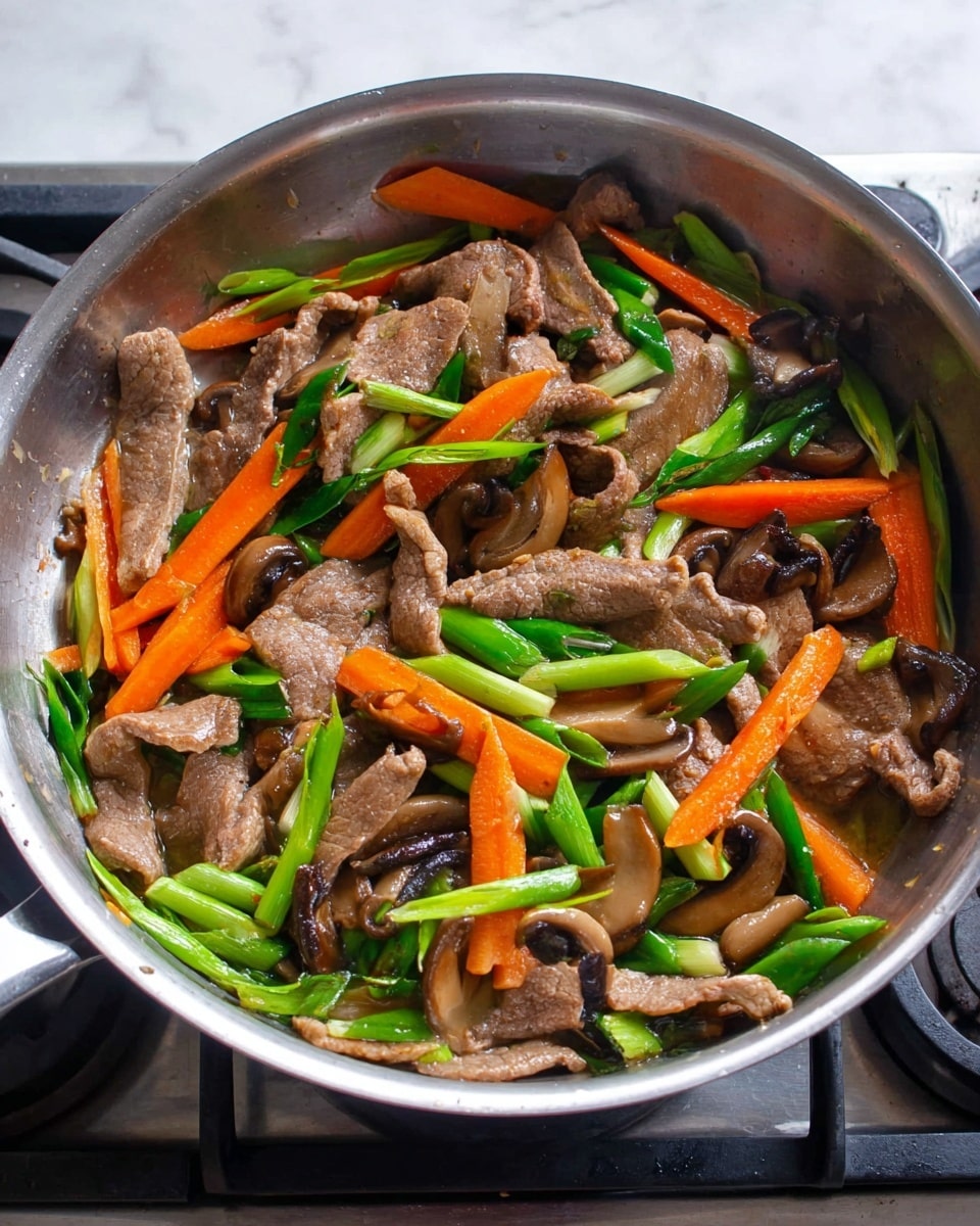 In a silver pan, thin slices of cooked light brown meat are mixed with bright orange carrot sticks, dark brown mushroom slices, and long green pieces of green onion. The ingredients are scattered evenly throughout the pan, showing a fresh and colorful stir-fry with a mix of soft and crisp textures. The pan is placed on a stove with a visible stove burner underneath, and the background has a clean white marbled surface. photo taken with an iphone --ar 4:5 --v 7