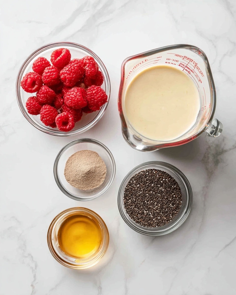 The image shows six small containers on a white marbled surface. At the top right is a clear glass measuring cup filled halfway with a creamy beige liquid. To the left of it is a small clear bowl filled with bright red raspberries. Below the raspberries, there is a smaller clear bowl with light brown powder. Next to it, on the right, is a medium clear bowl full of tiny black and white chia seeds. At the bottom center is a very small clear bowl with light golden honey. Everything is arranged neatly and evenly spaced, with good natural light highlighting the colors and textures, photo taken with an iphone --ar 4:5 --v 7