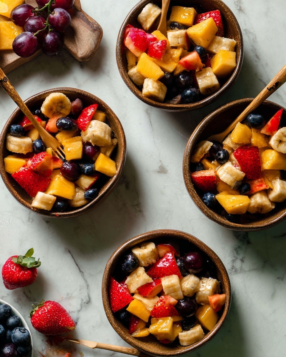 Four round brown bowls are filled with mixed fruit salad placed on a white marbled surface. Each bowl contains chunks of yellow-orange mango, light tan banana slices, red strawberry pieces, dark blue blueberries, and red apple cubes. Small wooden-handled picks poke into some of the fruit pieces in three of the bowls. On the surface near the bowls, there are a few loose strawberries, grapes, and blueberries. The overall look is fresh, colorful, and vibrant with different fruit textures. photo taken with an iphone --ar 4:5 --v 7