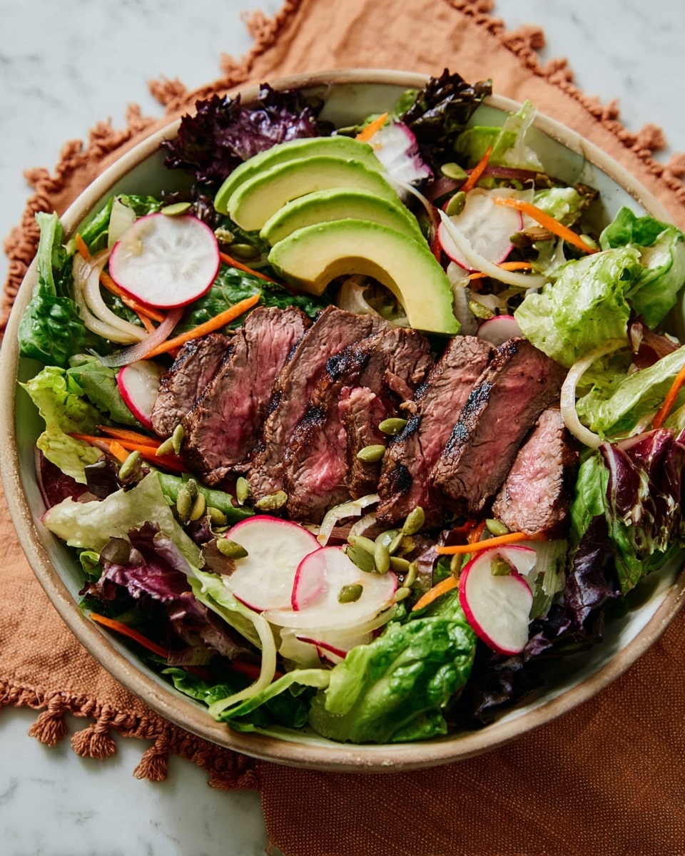 A large round white bowl filled with a fresh salad of mixed green and purple lettuce leaves forming the base layer. On top, there are slices of grilled steak arranged in the center with a pinkish inside and charred edges. Around the steak, thin slices of avocado with smooth light green color are spread evenly. Thin carrot rounds, white onion slices, and radish rounds with a red edge are scattered throughout the salad. Small green pumpkin seeds are sprinkled over the whole dish. The bowl sits on a beige cloth with knots on a white marbled surface. Photo taken with an iphone --ar 4:5 --v 7