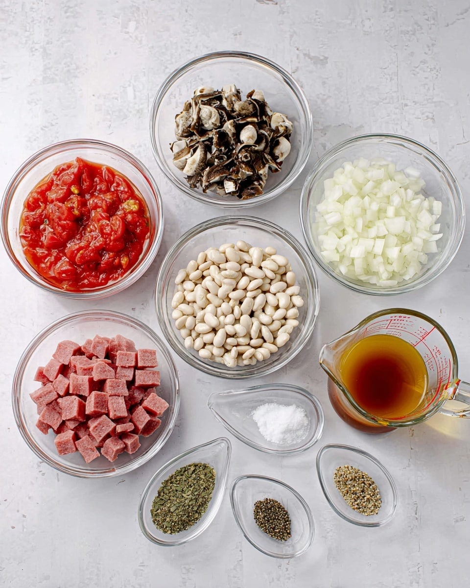 The image shows eight clear glass bowls and a glass measuring cup arranged on a white marbled surface. Starting from the top left, one bowl holds a red tomato mixture with pieces of tomato visible. To its right, a bowl contains torn dark and white pieces of what looks like cooked meat or mushrooms. Below the tomato bowl is a bowl filled with white beans with small black spots. In the middle is a bowl of pink diced meat cubes, and to its right is a bowl of small white chopped onions. In front of these larger bowls are four small clear oval dishes, each containing a different spice or seasoning: minced garlic, dried green herbs, white salt, and black pepper. On the far right is a glass measuring cup filled with a layered brown and yellow liquid mixture. The items are neatly placed, evenly spaced out, and no utensils or hands are shown. photo taken with an iphone --ar 4:5 --v 7