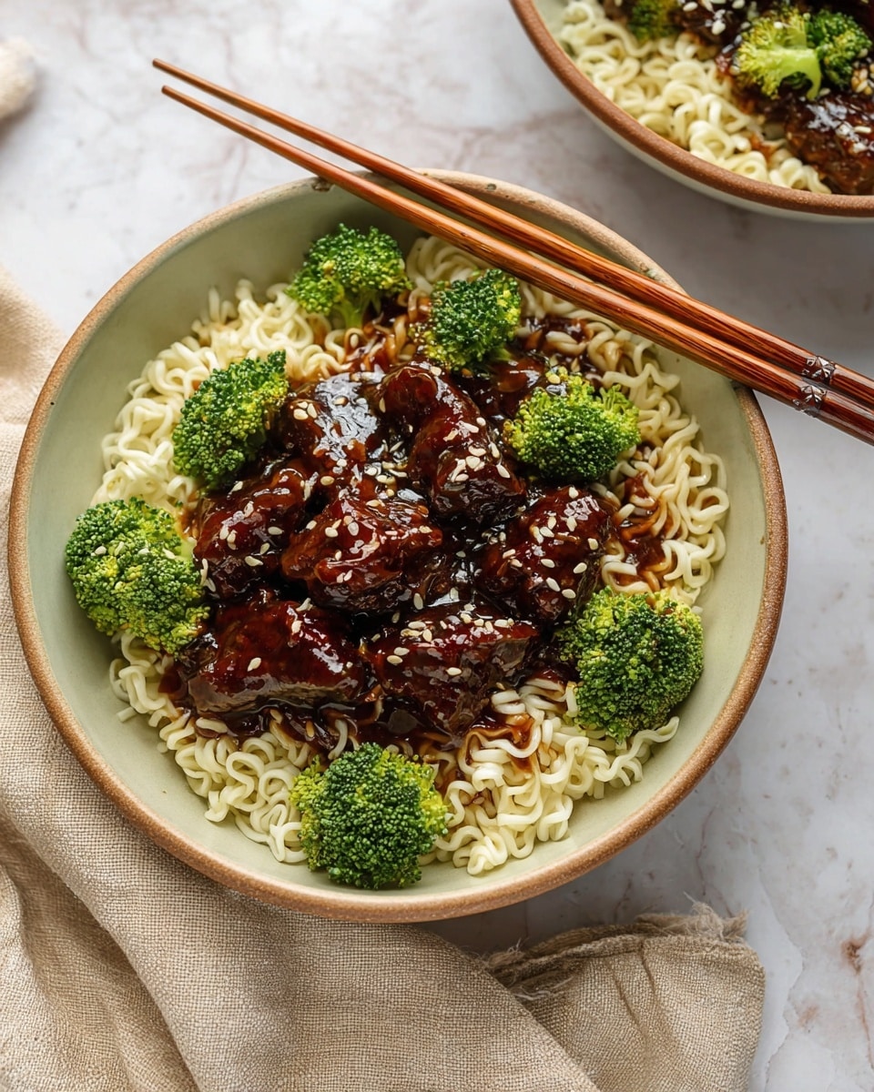 A white bowl filled with a base layer of light cream-colored noodles with a soft, curly texture. On top, there are several dark brown glazed pieces of meat, covered in a shiny sauce, with scattered bits of white sesame seeds adding small specks. Bright green broccoli florets are placed evenly over the meat, adding a fresh contrast. A pair of wooden chopsticks rest across the bowl’s edge, showing fine grain texture. The bowl sits on a white marbled surface with a light beige fabric napkin nearby. photo taken with an iphone --ar 4:5 --v 7