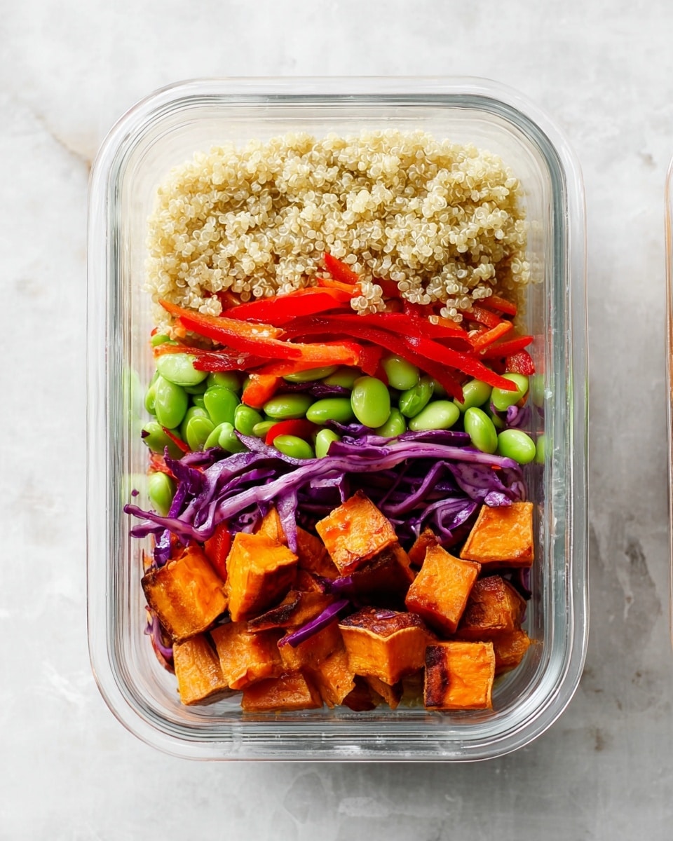 A clear glass meal prep container on a white marbled surface holds a three-layered dish. The top layer is light beige quinoa with a soft, grainy texture filling the upper third. Below it, a colorful mix of bright green edamame beans, thin red bell pepper strips, and shredded purple cabbage forms the middle layer, creating a fresh vibrant look. The bottom layer consists of roasted orange sweet potato cubes with some brown edges, adding a warm and hearty feel. The layers are neatly separated, showing their colors clearly. Photo taken with an iphone --ar 4:5 --v 7
