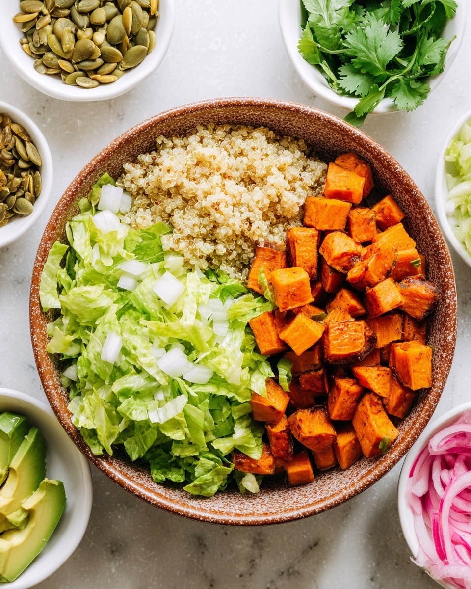 The image shows a bowl with three visible layers. The bottom half of the bowl is filled with light green chopped lettuce with a fresh, crisp texture. On the left side of the bowl, there is a portion of light beige cooked quinoa, with small grainy texture. On the right side, there are bright orange, roasted sweet potato cubes with a slightly charred surface. The bowl is a rustic brown with speckled design, placed on a white marbled surface. Surrounding the bowl are small white bowls filled with various ingredients including diced avocado, pumpkin seeds, pickled red onions, and fresh green cilantro leaves. Photo taken with an iphone --ar 4:5 --v 7