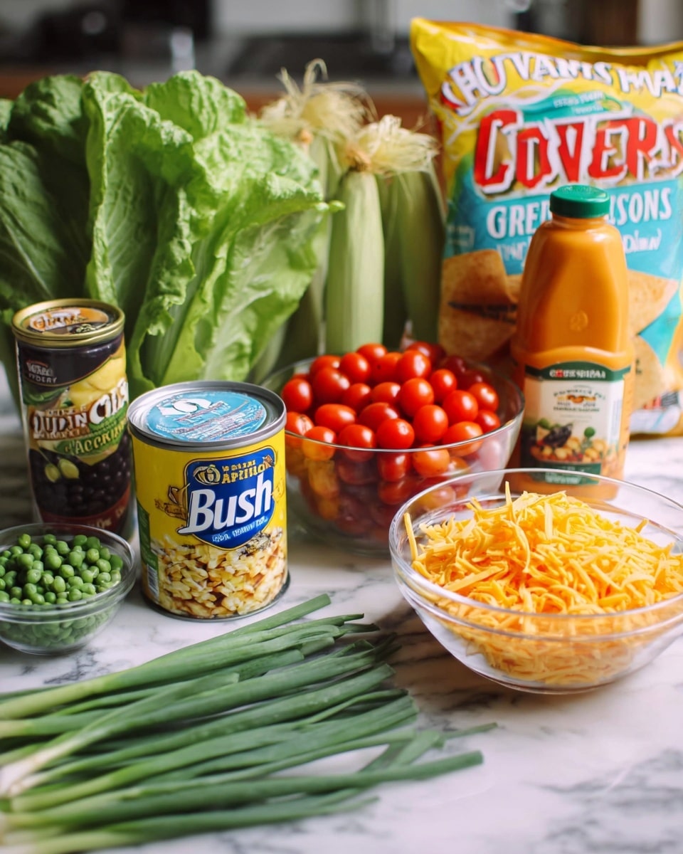 The image shows a kitchen countertop with several ingredients arranged in layers against a white marbled background. At the front on the lower layer, there are fresh green scallions spread horizontally and a glass bowl filled with shredded orange cheese on the right. Just behind these, a can of Bush's Organic black beans with a light yellow and blue label stands next to the cheese. To the left, there is a small can of peas partially hidden behind large, leafy green lettuce. A clear glass bowl filled with bright red cherry tomatoes sits in the center, behind the beans and scallions. On the upper layer, a bottle of orange Great Value French Style dressing stands upright next to a large colorful white bag of Great Value Corn Chips. Green corn husks are partially visible on the left side, completing the spread. The whole scene is brightly lit with a casual kitchen feel, photo taken with an iphone --ar 4:5 --v 7