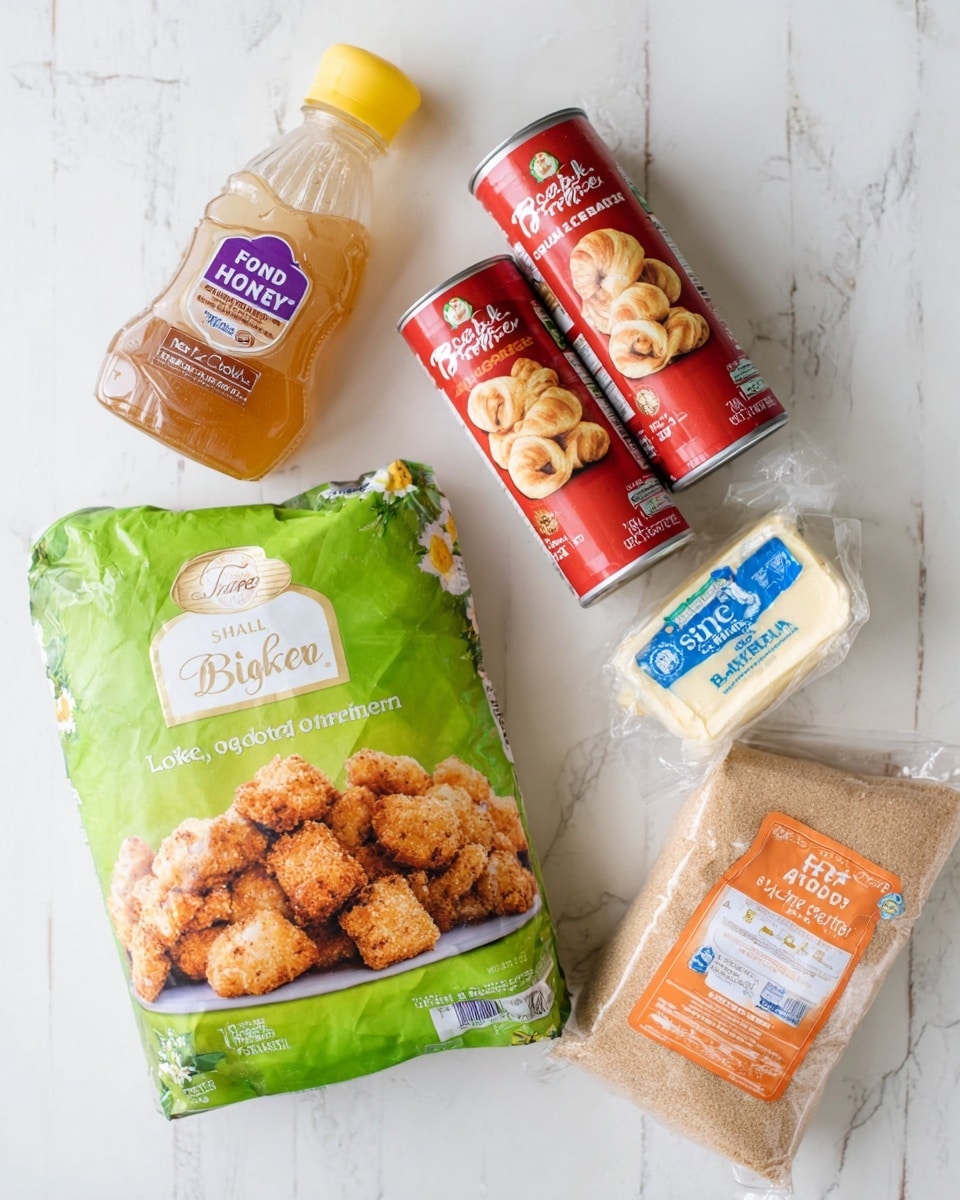 The image shows six food items arranged on a white marbled surface. There is a green bag of lightly breaded chicken bites with a picture of crispy golden brown chicken pieces on the front at the center. Above it to the left is a clear plastic bottle of organic raw honey with a yellow cap and a purple label. To the right of the honey are two red cylindrical cans of crescent rolls lying side by side, showing golden rolled pastry images. Next to the cans on the right is a small block of butter wrapped in blue and white paper. Finally, at the bottom right corner, there is a large clear plastic bag of light brown sugar with an orange and white label. Photo taken with an iphone --ar 4:5 --v 7