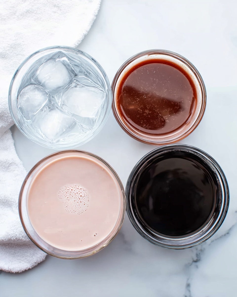 The image shows four clear glass bowls placed on a white marbled surface. The top left bowl contains several ice cubes that are transparent with a slight shine. The top right small bowl holds a dark reddish-brown thick sauce, with a smooth texture. The bottom left bowl has a light pink creamy liquid, evenly smooth with tiny bubbles on top. The bottom right bowl is filled with a dark almost black liquid, smooth and glossy. A soft white towel is partially visible in the upper background. Photo taken with an iphone --ar 4:5 --v 7