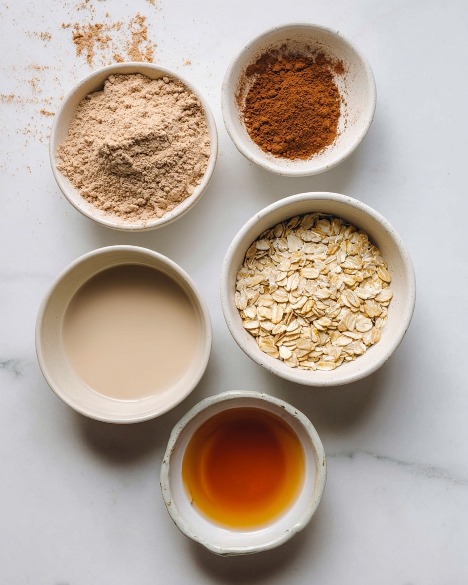 Five white bowls sit on a white marbled surface. Starting from the top left is a bowl with light brown powder, with some scattered powder around the edge. To the top right is another smaller bowl with a darker brown powder spread evenly inside. Below the first bowl, near the bottom left, is a bowl filled with a light beige liquid. To the right of this bowl is a bowl filled with light tan rolled oats. At the bottom center is a small bowl filled with a clear amber liquid. photo taken with an iphone --ar 4:5 --v 7