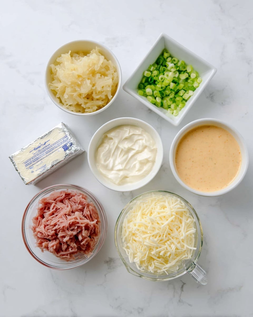 The image shows six white dishes and a glass measuring cup arranged neatly on a white marbled surface, each containing a different ingredient. Starting from the top left, there is a small white bowl filled with light yellow sauerkraut, next to it on the right, a square white bowl holds finely chopped green onions. Below that, another square white bowl contains a creamy light orange sauce with a smooth texture. In the center, a round white bowl has a creamy white ingredient that looks like sour cream or mayonnaise. To its right, there is a silver-wrapped block of cream cheese placed directly on the white marbled surface. At the bottom center, a clear glass measuring cup is filled with shredded pale yellow cheese. Near the top center, a small round white bowl with shredded pink meat completes the arrangement. Photo taken with an iphone --ar 4:5 --v 7