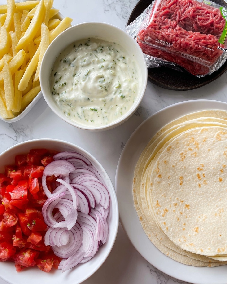 This image shows a white bowl full of thin, pale yellow fries with a smooth texture arranged neatly inside. Next to it, there is a white round bowl filled with creamy, white sauce that has green herb bits mixed in, giving it a slightly chunky texture. Below, a white plate holds two layers: a bottom layer of red chopped tomatoes evenly spread, and a top layer of thin, pale purple onion slices placed over the tomatoes. To the right, a plate with a black surface displays six pale white soft tortillas stacked evenly, with a packed piece of raw, red ground beef with visible fat marbling placed nearby. The whole scene is set on a white marbled surface. Photo taken with an iphone --ar 4:5 --v 7