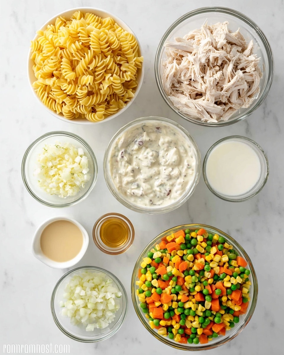 The image shows seven clear glass bowls and one white colander placed on a white marbled surface. The white colander at the top left is filled with yellow cooked egg noodles with a twisted shape. To the right, a glass bowl holds shredded cooked light-colored chicken. Below the chicken, another glass bowl contains a thick white creamy mixture with visible small dark bits. Next to it is a small white cup with a clear liquid, likely milk. At the bottom right, a large glass bowl is full of a colorful mix of green peas, orange carrots, yellow corn, and orange diced vegetables. Toward the bottom left, a small glass bowl has finely chopped white onions, and above it is an even smaller bowl with minced garlic. Near the middle left, a small glass bowl contains a yellow creamy sauce, and beside it is a small white cup with a light brown liquid. The overall scene is neat and organized. Photo taken with an iphone --ar 4:5 --v 7