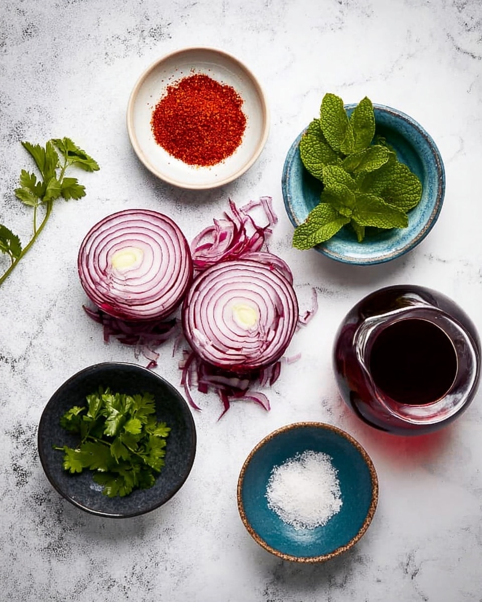 The image shows various ingredients placed on a white marbled surface, arranged in a loose circle. In the center, there are two halves of a red onion with their purple and white rings visible, resting on some red onion peel. Around the onions, there are five small dishes: a white bowl with green mint leaves at the top right, a blue bowl with red chili powder at the top center, a dark bowl with green parsley leaves at the bottom left, a small dark bowl with white salt at the bottom center, and a clear glass jug filled with dark red liquid at the bottom right. The colors are bright and fresh, and the scene is well lit, showing clear details of each ingredient. photo taken with an iphone --ar 4:5 --v 7