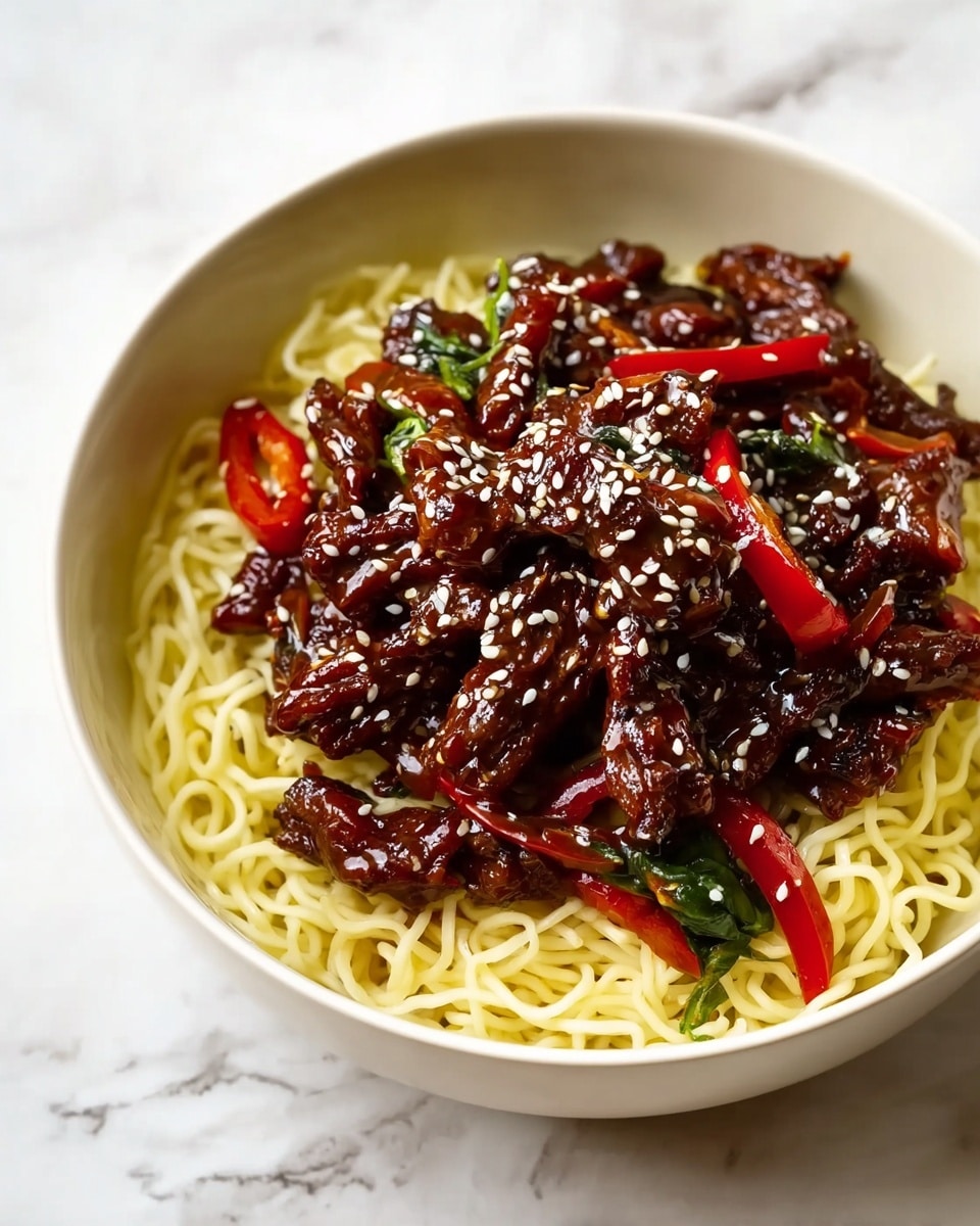 A white bowl holds thin yellow noodles as the bottom layer with a smooth texture. On top, there is a thick layer of dark brown meat strips glazed with a shiny sauce. Mixed in with the meat are thin red chili slices and dark green leafy bits. White sesame seeds are sprinkled evenly over the meat, adding a small contrast. The bowl sits on a white marbled surface. photo taken with an iphone --ar 4:5 --v 7
