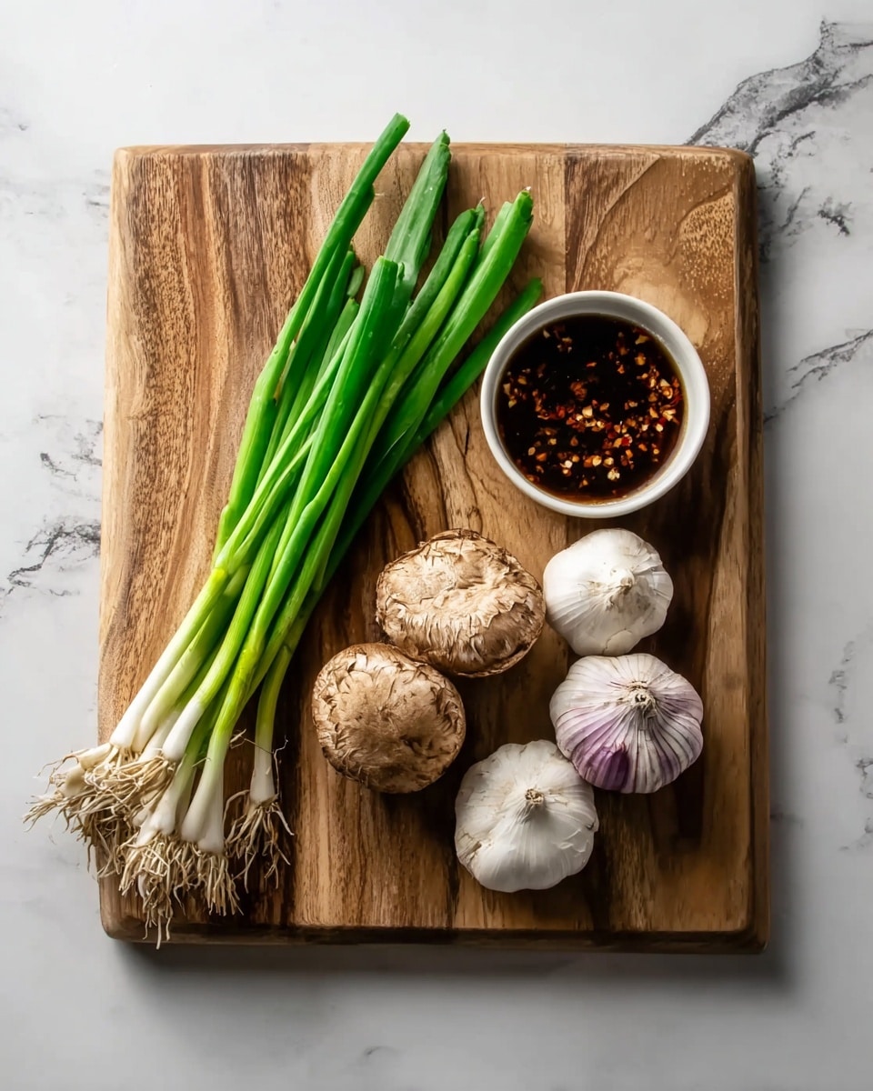 A wooden cutting board sits on a white marbled surface, holding fresh green onions with long green stalks and white ends on the left side. Next to them are two mushrooms with a rough light brown texture in the middle. To the right of the mushrooms are two whole garlic bulbs with white and purple skins. At the top right corner of the board, a small white bowl contains dark brown sauce with red chili flakes floating in it. The scene is clean and bright, showing the natural colors and textures of the ingredients clearly. Photo taken with an iphone --ar 4:5 --v 7