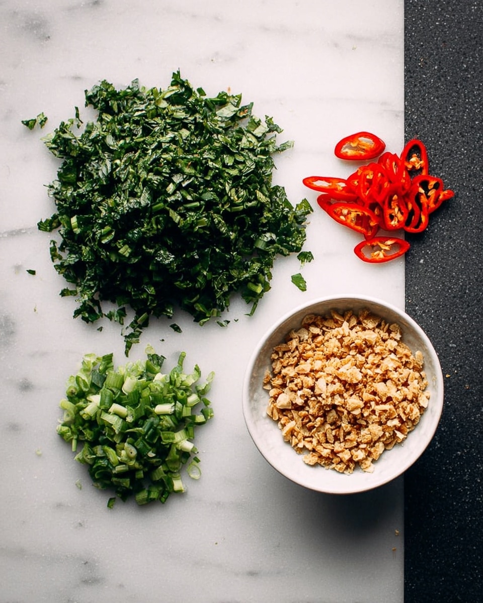 On a white marbled surface, there are four groups of ingredients: in the top left is a large pile of chopped green herbs with a leafy texture, below it is a smaller pile of chopped green onions with a tubular shape, on the top right are thin slices of red chili arranged loosely, and in the bottom right sits a white bowl filled with small, light brown crumbled pieces that have a dry, crumbly texture. The scene is well lit with natural light showing clear detail and texture across all elements, photo taken with an iphone --ar 4:5 --v 7