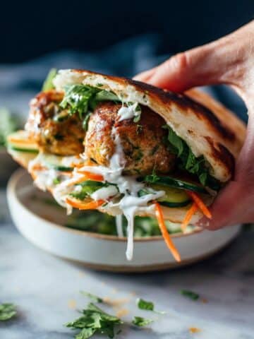 Ginger Chicken Meatball Sandwiches with Cilantro, Mint, and Chili Crisp Recipe