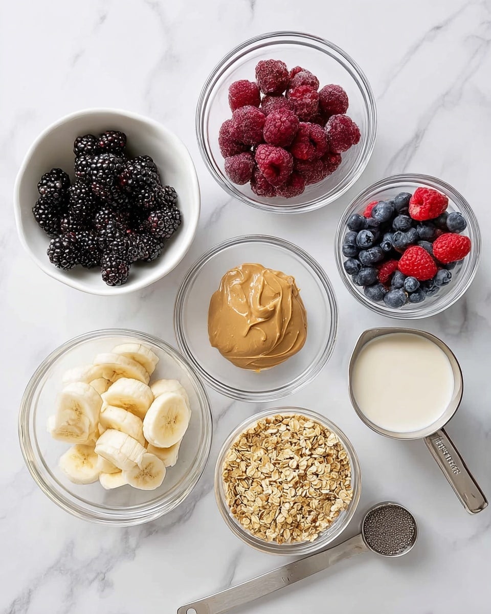 The image shows seven clear glass bowls and white bowls placed on a white marbled surface. Starting from the top left, a white bowl is filled with dark blackberries and deep red raspberries. Next to it is a clear glass bowl with a smooth scoop of light brown peanut butter. To the right, there is a clear glass bowl with a small colorful mix of blackberries, blueberries, and raspberries. Below, on the left, a white bowl contains sliced frozen bananas that are light yellow. In the center is a clear glass bowl filled with small, dark chia seeds. To the right, there is a clear glass bowl filled with golden granola. At the bottom right is a small metal measuring cup filled with creamy light beige milk. photo taken with an iphone --ar 4:5 --v 7