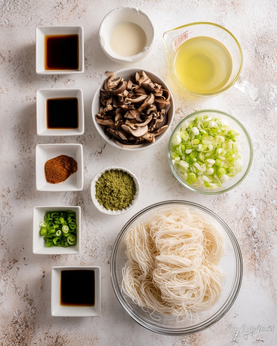 A top-down view shows a set of clear and white bowls arranged neatly on a white marbled surface. There are two larger clear bowls, one filled with thin, pale rice noodles at the bottom right and another filled with dark brown sliced mushrooms at the top left. Surrounding them are smaller white bowls containing various ingredients: a light yellow liquid in a glass measuring cup at the top right, a white creamy liquid nearby, bright green sliced spring onions and pale green chopped scallions in separate bowls next to each other toward the middle right, and a small bowl of green zest. On the left side, there are white square and round bowls with dark soy sauce, yellow oil, a brown sauce, chopped pale ginger, and a paste-like brownish substance. The layout is clean and organized, set on a textured white marbled surface. photo taken with an iphone --ar 4:5 --v 7