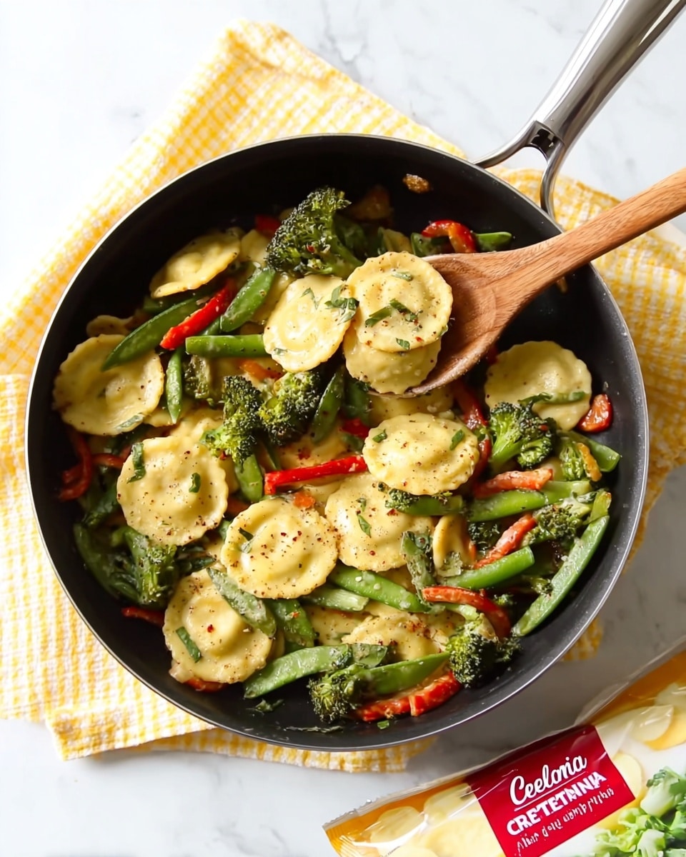 A close-up top view of a black frying pan filled with around two layers of cheese ravioli, bright green broccoli florets, green snap peas, and red bell pepper strips, all mixed together with a light seasoning that gives the ravioli a slight golden brown texture. A wooden spoon rests inside the pan, scooping some ravioli and vegetables, showing the mix’s texture clearly. The pan is placed on a white marbled surface with a yellow and white checked cloth underneath and a partially visible white cheese ravioli package at the bottom right. Photo taken with an iphone --ar 4:5 --v 7