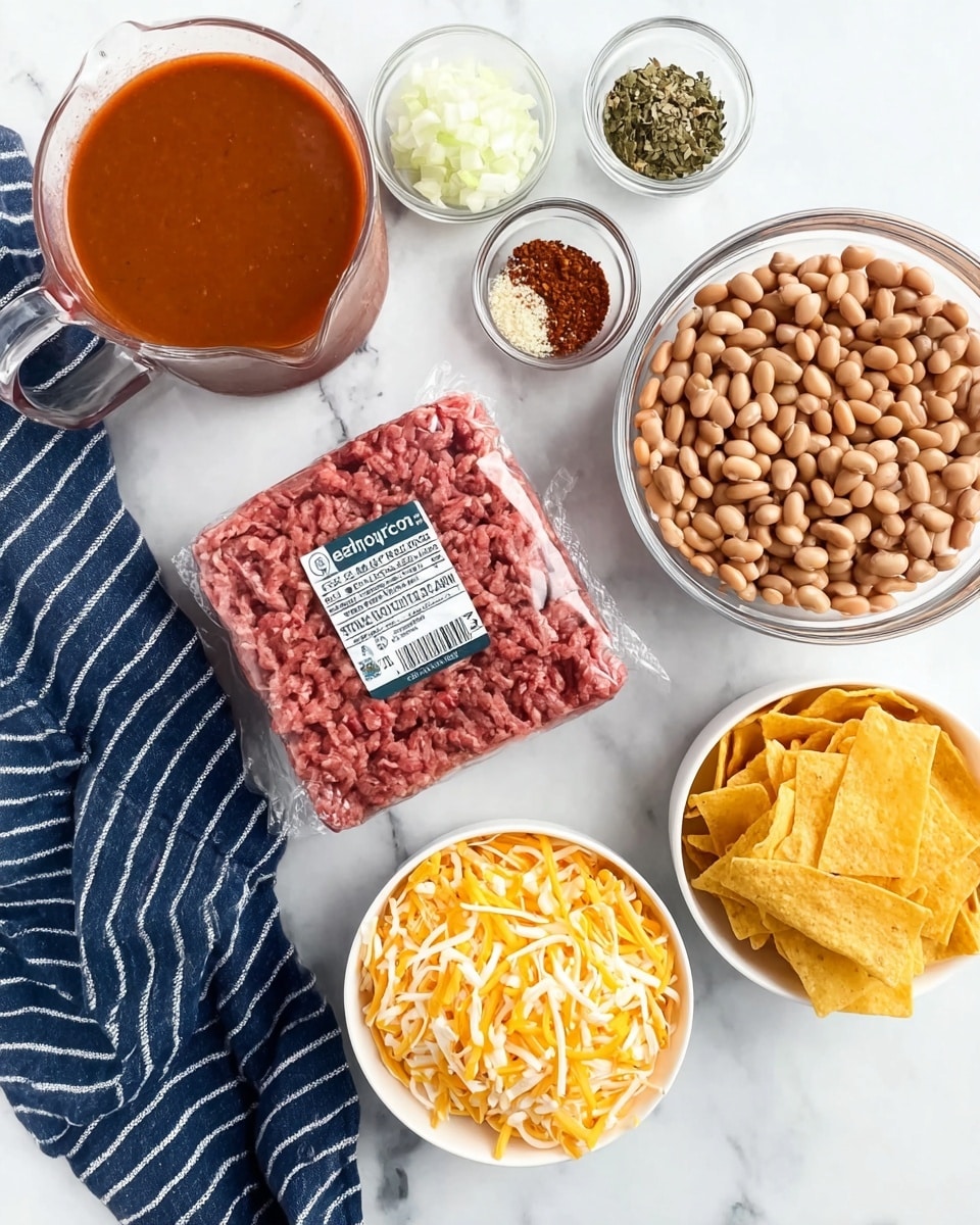 The image shows several ingredients arranged on a white marbled surface. At the center is a square pack of raw ground beef with a label. Surrounding it, on the right, are two clear glass bowls: one with light brown beans and the other with finely chopped white onions. In the bottom center, there is a white bowl filled with shredded cheese in a mix of yellow and white colors. On the top right, a white bowl holds yellow tortilla strips. To the left of the beef, a small clear bowl contains a mix of spices in different colors — green, red, and white. Above that is a clear measuring cup filled with a smooth reddish-brown sauce, and next to the ingredients is a dark blue cloth with white stripes. Photo taken with an iphone --ar 4:5 --v 7