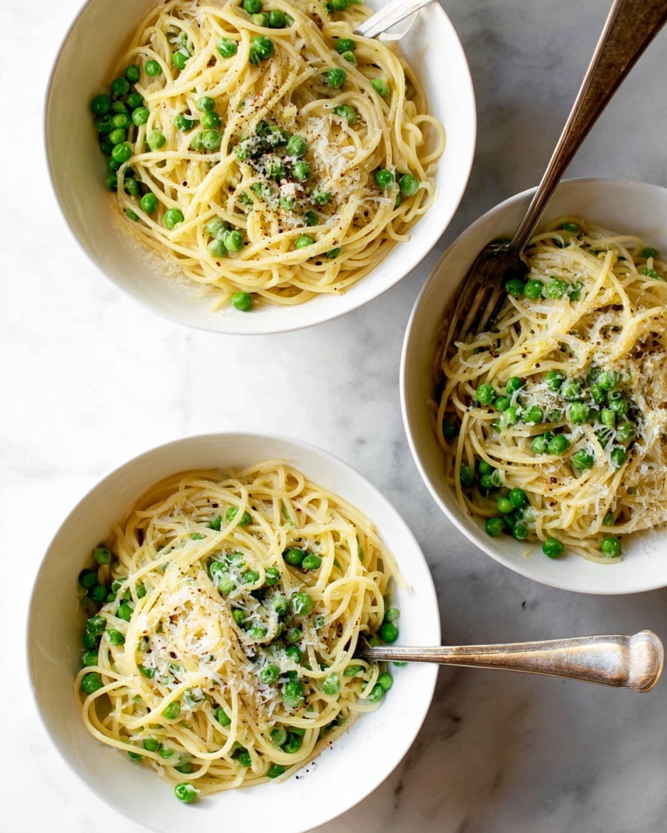 Three white bowls filled with yellow spaghetti mixed with bright green peas. Each bowl shows a similar portion of pasta, with a sprinkle of light-colored grated cheese and small black pepper flakes on top. The spaghetti layers look soft and slightly oily, giving a shiny texture. Each bowl has a fork with a wooden handle resting inside, ready to eat, placed on a white marbled surface. Photo taken with an iphone --ar 4:5 --v 7