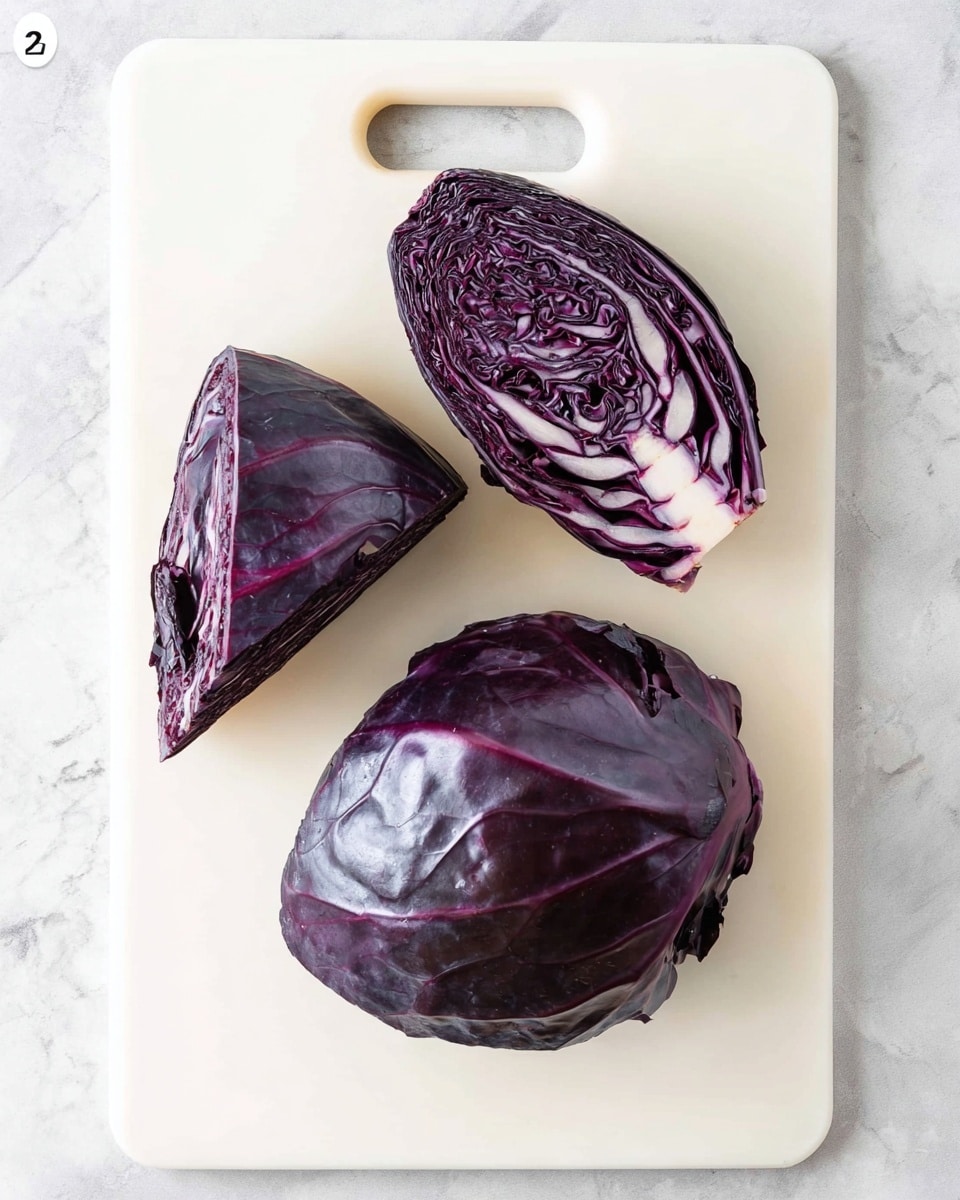 The image shows three pieces of red cabbage placed on a white cutting board with a handle cutout at the top. The largest piece is a half head of red cabbage with smooth, dark purple outer leaves and a slight shine, positioned on the bottom right. Another half head piece, slightly smaller, lies above it towards the top right, with similar dark purple smooth outer leaves. The third piece is a narrow triangular wedge showing the inside layers with a deep purple color and white veins, positioned at the top left. The board is on a white marbled surface. Photo taken with an iphone --ar 4:5 --v 7