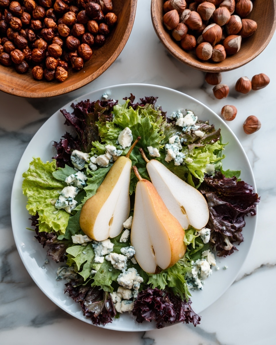 A large wooden bowl holds a fresh salad made of mixed green and purple leafy lettuce as the base layer, with clusters of crumbled blue cheese spread evenly on top. Two bright red pear halves, sliced thin, are placed neatly on opposite sides of the bowl. A small pile of round hazelnuts sits in the center, adding texture and color contrast. The bowl is placed on a dark wooden table with a white and lilac striped cloth partially visible in the corner. Photo taken with an iphone --ar 4:5 --v 7
