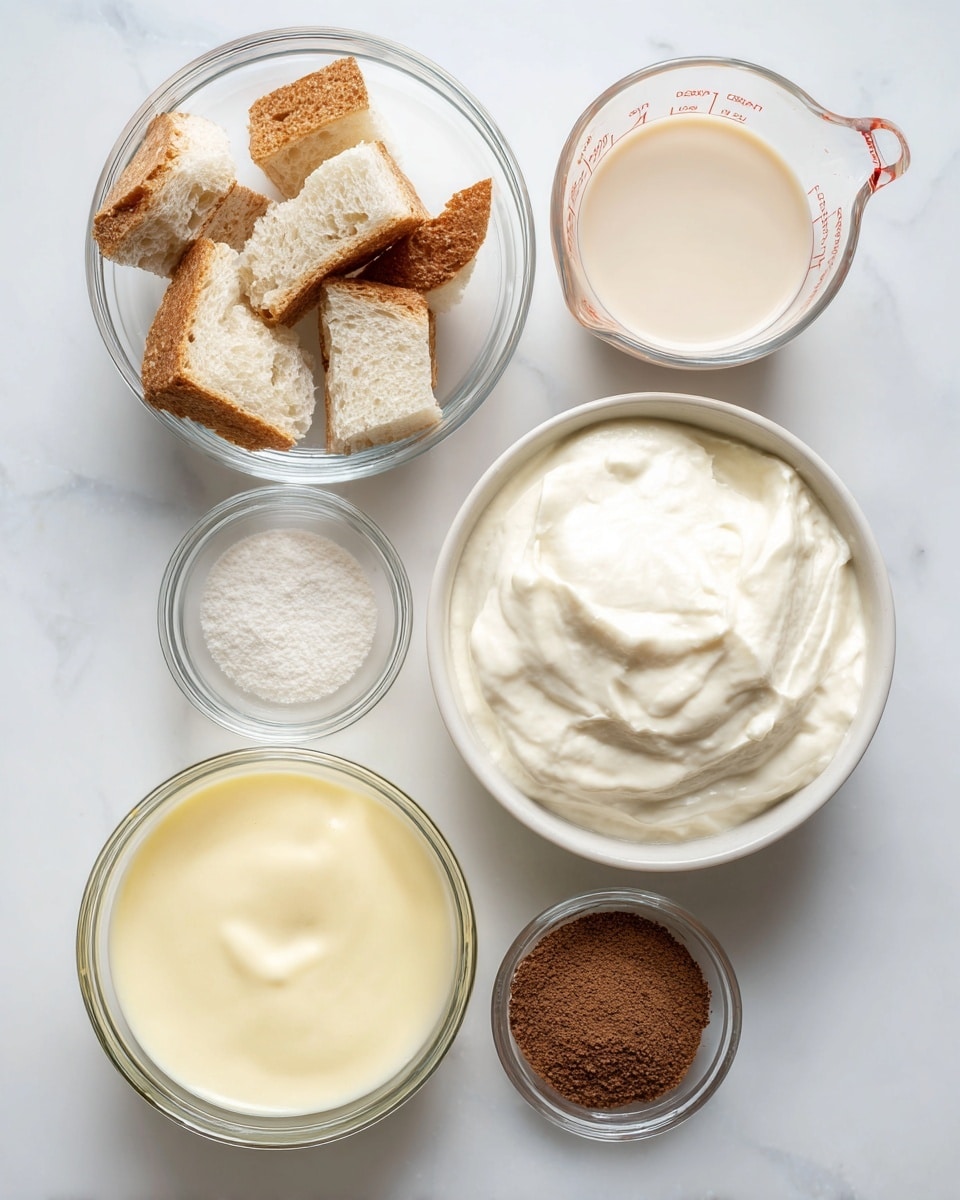 The image shows five glass and ceramic bowls placed on a white marbled surface. The top left bowl contains small pieces of torn white bread with light brown crusts. The top right glass measuring cup has a light beige liquid inside. Below that, in the bottom right, is a white bowl filled with thick, creamy white yogurt or sour cream. To the bottom left, there is another glass bowl with a pale yellow liquid, smooth in texture. In the middle is a small clear bowl filled with a small amount of fine brown powder. All bowls are arranged neatly and viewed from above, with soft natural light highlighting the textures. Photo taken with an iphone --ar 4:5 --v 7