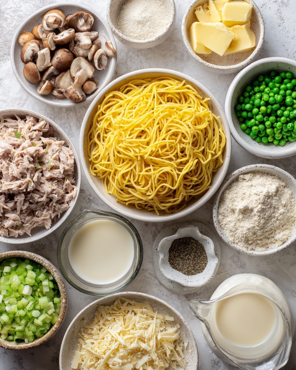 An overhead view shows a white marbled surface with many small white bowls and one larger white bowl holding different food ingredients. The large bowl holds bright yellow twisted egg noodles. Surrounding it are bowls with chopped green celery, sliced brown mushrooms, green peas, chopped white onion, and light brown tuna chunks. Smaller dishes contain light yellow butter, finely grated yellow zest, white flour, white and black ground spices in a small scalloped dish, light brown crumbs, pale white and creamy liquids in glass pitchers, and a bowl of light vinegar or broth. The colors and textures are a mix of fresh vegetables, dry pasta, smooth liquids, and seasonings, all clean and neatly arranged photo taken with an iphone --ar 4:5 --v 7