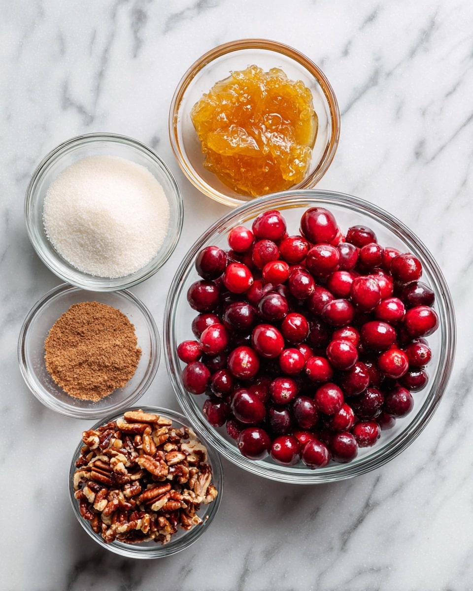 Five clear glass bowls sit on a white marbled surface. The largest bowl, in the center, holds a pile of fresh bright red cranberries with smooth and shiny skin. To its left, a medium bowl contains fine white granulated sugar, and above it, a smaller bowl holds a thick, chunky orange-yellow marmalade. To the right of the cranberries, a medium bowl is filled with small, rough-textured brown chopped pecans. Above that, a tiny bowl contains a small amount of light brown cinnamon powder. The setup is clean and simple, all ingredients clearly visible and evenly spaced, photo taken with an iphone --ar 4:5 --v 7