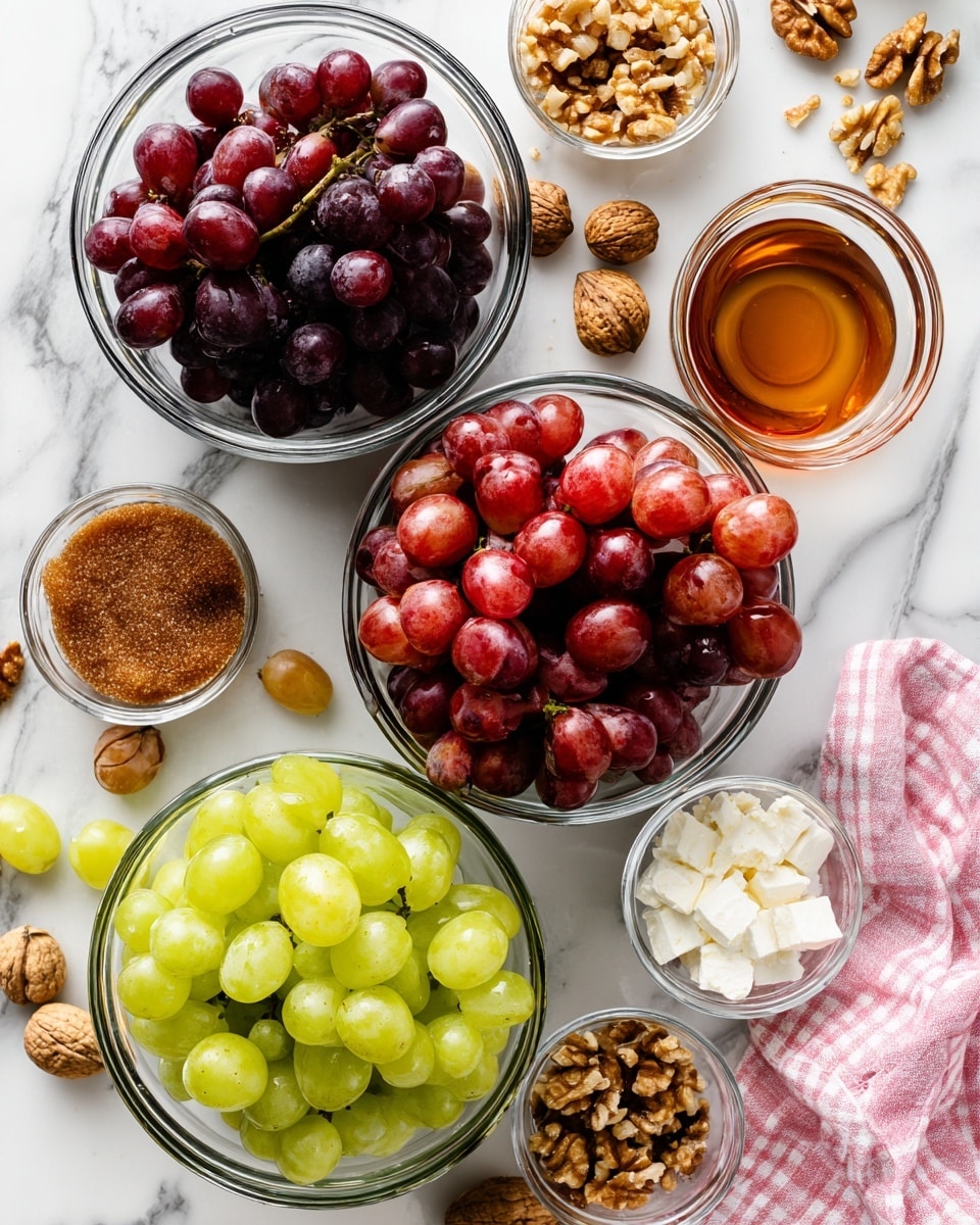 The image shows an overhead view of several clear glass bowls filled with different colored grapes and ingredients arranged on a white marbled surface. There are three main bowls with grapes: one with dark purple grapes at the bottom left, one with light green grapes at the bottom right, and one with red grapes near the top center. Smaller bowls hold chopped nuts, a brown sugar-like ingredient, a small amount of brown liquid, and white creamy ingredients. Around the bowls are some loose grapes, walnut halves, and a pink and white checkered cloth on the right side. The setup looks neat and organized for food preparation or serving photo taken with an iphone --ar 4:5 --v 7