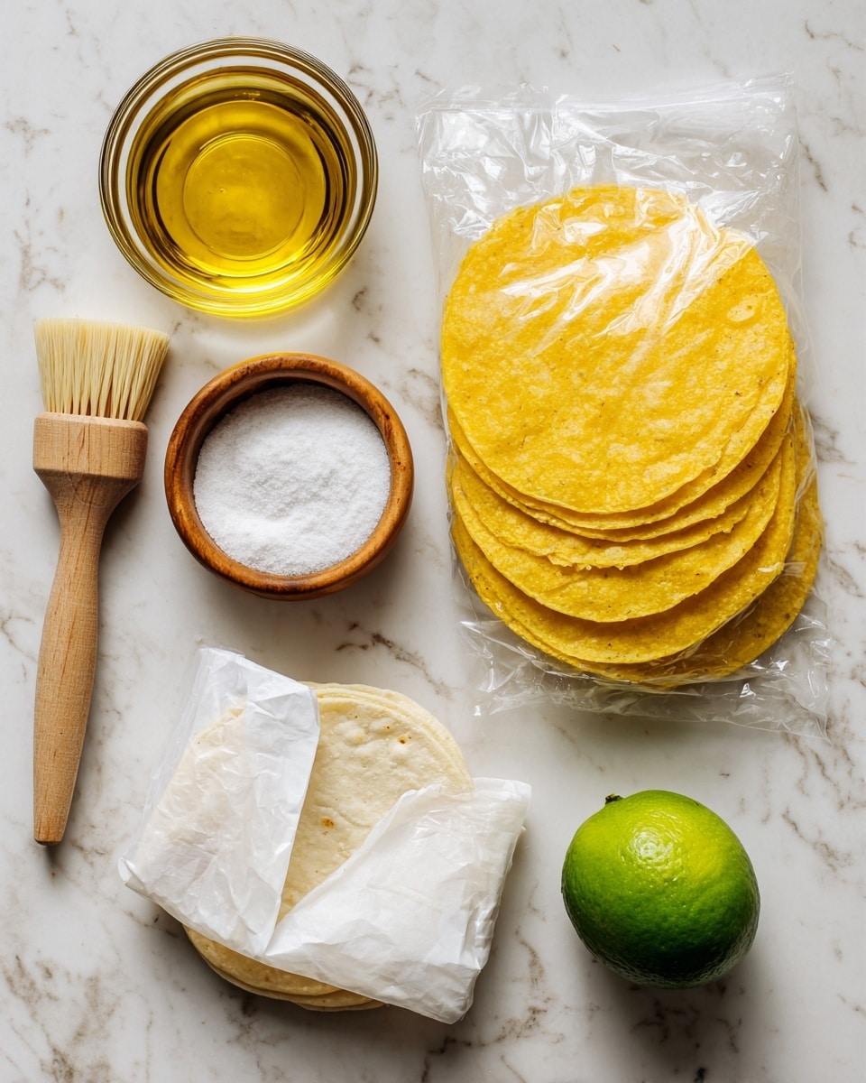 A flat lay of ingredients on a white marbled surface includes a clear glass bowl filled with golden oil at the top left, next to a wooden brush with soft brown bristles. Below this is a small round wooden bowl of white salt. To the right, a clear plastic bag of yellow corn tortillas is shown, with several yellow tortillas visible through the bag. At the bottom left, a partially open white paper package reveals white corn tortillas inside. On the bottom right, there is a whole bright green lime. photo taken with an iphone --ar 4:5 --v 7