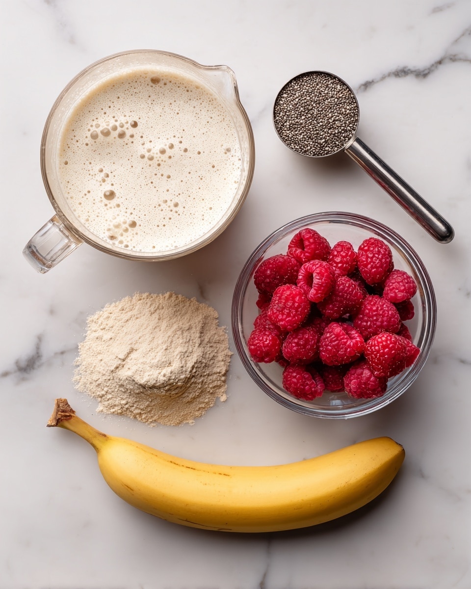 The image shows five ingredients on a white marbled surface: at the top right, a clear glass bowl filled with bright red raspberries; to the left, a clear glass measuring cup with cream-colored liquid and bubbles on top; below it, a clear scoop of light beige powdered protein; next to the scoop, a longer yellow peeled banana; and above the banana, a metal measuring spoon filled with small chia seeds. Photo taken with an iphone --ar 4:5 --v 7
