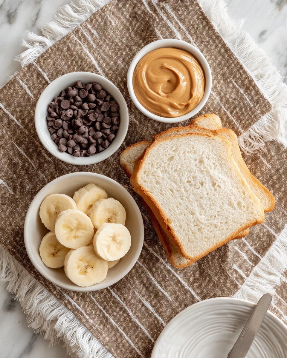 The image shows a simple setup on a brown textured cloth with white vertical lines and fringes on the edges, placed on a white marbled surface. There are two slices of white bread with a light golden crust stacked slightly off to the right side. Near the bread, there is a small white bowl filled with smooth, light brown peanut butter. Below it, a white bowl contains several slices of banana, each pale yellow with light brown centers. A smaller white bowl with dark chocolate chips sits to the left. In the bottom right corner, a white plate with a subtle circular pattern is partially visible, along with a silver butter knife resting on the cloth beside it. photo taken with an iphone --ar 4:5 --v 7