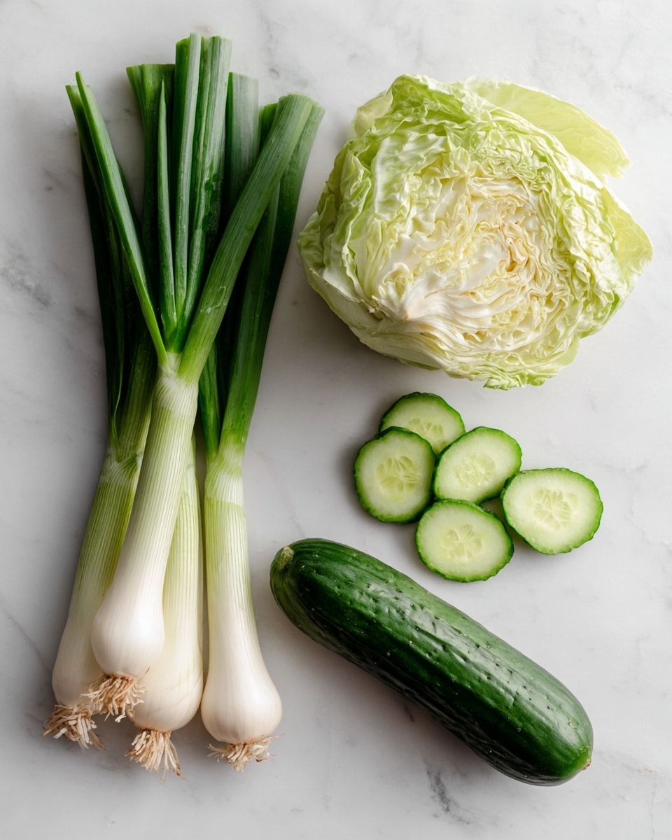 The image shows three main ingredients arranged on a white marbled surface: a bunch of long scallions with white bulbs and green stalks on the left side, a half white cabbage with many light green and creamy layers of leaves towards the top right, and a dark green cucumber whole with a shiny peel lying horizontally near the bottom right alongside a few round, light green cucumber slices placed nearby. Each ingredient is labeled clearly in bold black text on a white background close to them. photo taken with an iphone --ar 4:5 --v 7