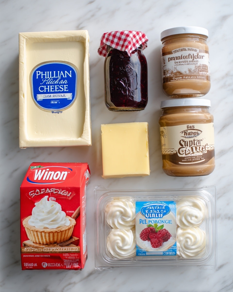 The image shows six baking ingredients arranged on a white marbled surface. On the top left is a beige rectangular box of Philadelphia original cream cheese with blue lettering. Next to it, in the center top, is a glass jar of Bonne Maman raspberry preserves with a dark red color inside and a red-and-white checkered lid. To the top right is a plastic jar of Skippy Natural creamy peanut butter with a light brown color and a dark brown lid. Below the cream cheese, on the lower left, is a red and white carton of WinCo whipping cream. In the center bottom is a rectangular block of yellow butter labeled