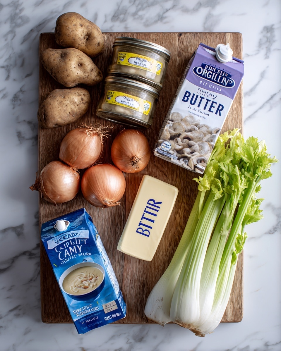 A wooden cutting board on a white marbled surface holds various cooking ingredients arranged neatly. On the left, two irregularly shaped brown potatoes with a rough texture sit close together. Next to them are two jars of minced clams stacked vertically with yellow labels and a can of whole baby clams below with a blue soup bowl image. Above the cans are two medium-sized brown onions with dry skins. To the right of the onions is a stick of butter with a rectangular shape and