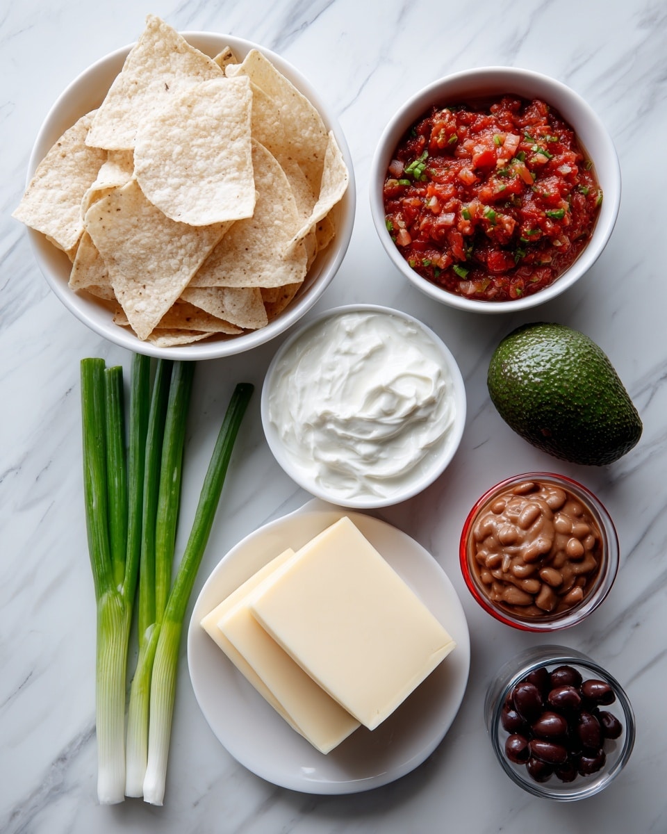 The image shows a collection of ingredients set on a white marbled surface, each in or beside white bowls except for one glass container and a red and white cup. One large white bowl is filled with light brown tortilla chips with a rough texture. A small white bowl holds fresh red pico de gallo mixed with green bits. Next to it, three green onions lie horizontally, their long green stalks and white bulbs visible. A whole dark green avocado is placed near them. A white plate has three thick square layers of pale yellow cheese stacked neatly. A small white bowl contains smooth, white sour cream. A glass square container holds thick, brown refried beans. Lastly, a small red and white cup holds several black sliced olives. photo taken with an iphone --ar 4:5 --v 7