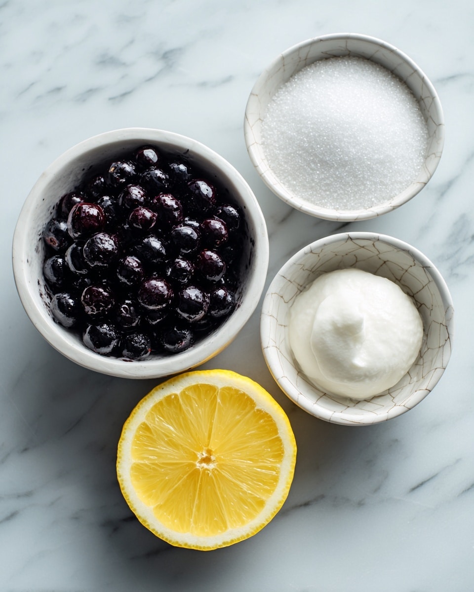 A white marbled surface holds four items arranged neatly: a white bowl filled with small blackberries that are shiny and dark purple, a white bowl with sugar grains that are white and granulated, a white bowl with a white powder and a white dollop on top, and a bright yellow half lemon showing its juicy inside. The bowls vary in patterns but all are white, sitting close together with a natural light shining on them. Photo taken with an iphone --ar 4:5 --v 7