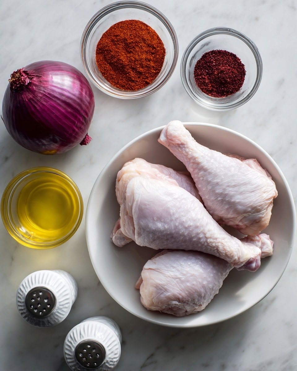 The image shows a white bowl on a white marbled surface holding two raw chicken drumsticks with pale pink and light gray skin. Above the bowl are two small clear glass bowls, one filled with reddish-brown harissa powder and the other with dark reddish-purple sumac powder. To the left of these bowls is a halved red onion with shiny purple and white layers. Below the onion is a clear glass cup filled with bright yellow olive oil. In the bottom left corner, there are two white rectangular salt and black pepper containers with ridged tops placed next to each other. The overall composition is clean and organized with a soft natural light. photo taken with an iphone --ar 4:5 --v 7