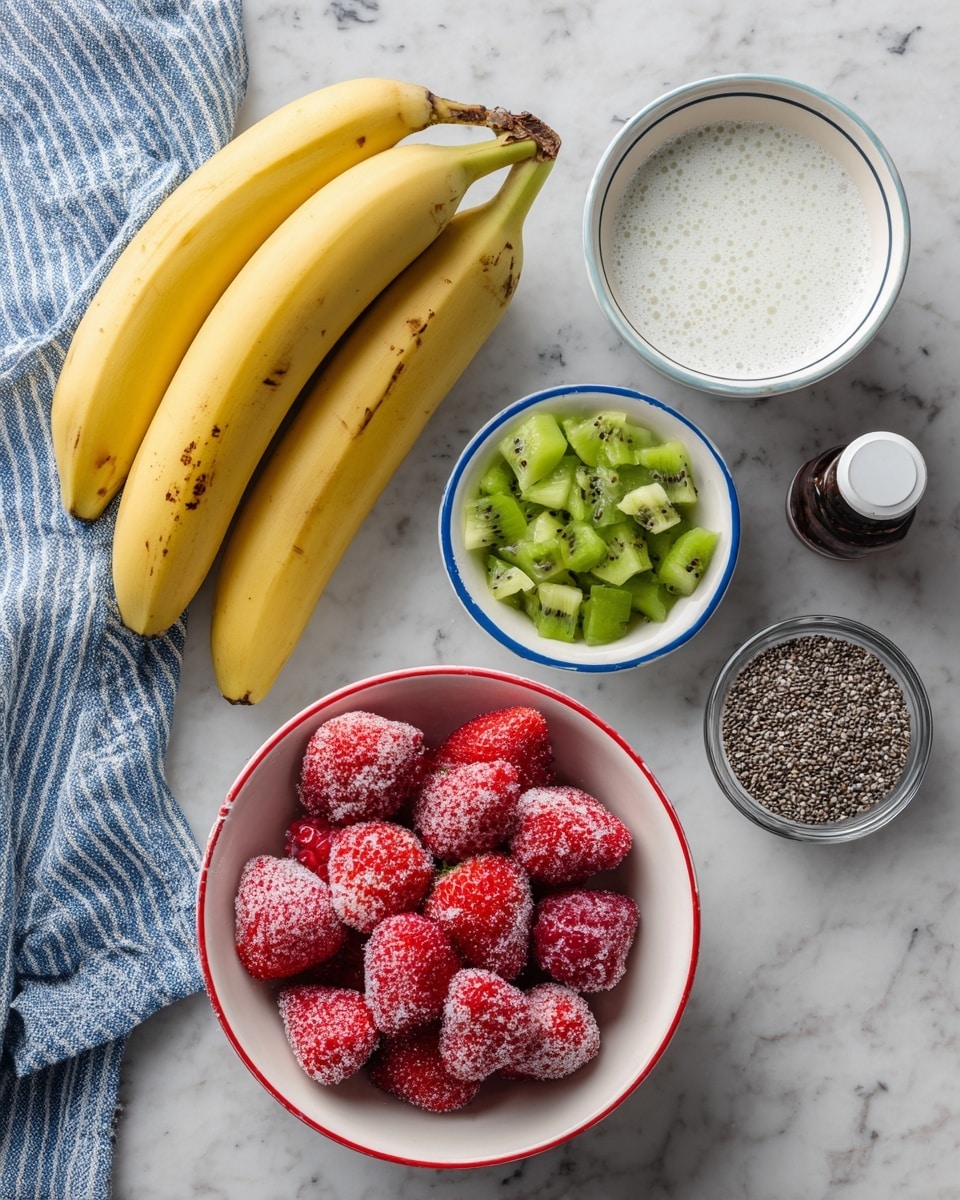 The image shows ingredients neatly arranged on a white marbled surface: at the bottom, a white bowl with a red rim filled with frozen strawberries covered in frost with bright red and light pink tones; above it to the left, a small white bowl with a blue rim containing bright green chopped kiwi pieces; to the right of the kiwi, a small clear glass bowl filled with tiny black and white chia seeds; next to the chia seeds is a small dark brown bottle with a white cap; above all bowls, two ripe yellow bananas with some brown spots on the peel lay side by side; in the top left corner, a white bowl with a blue rim filled with a creamy white liquid with a few bubbles on the surface; and a blue and white striped cloth peeks in from the top left corner. Photo taken with an iphone --ar 4:5 --v 7