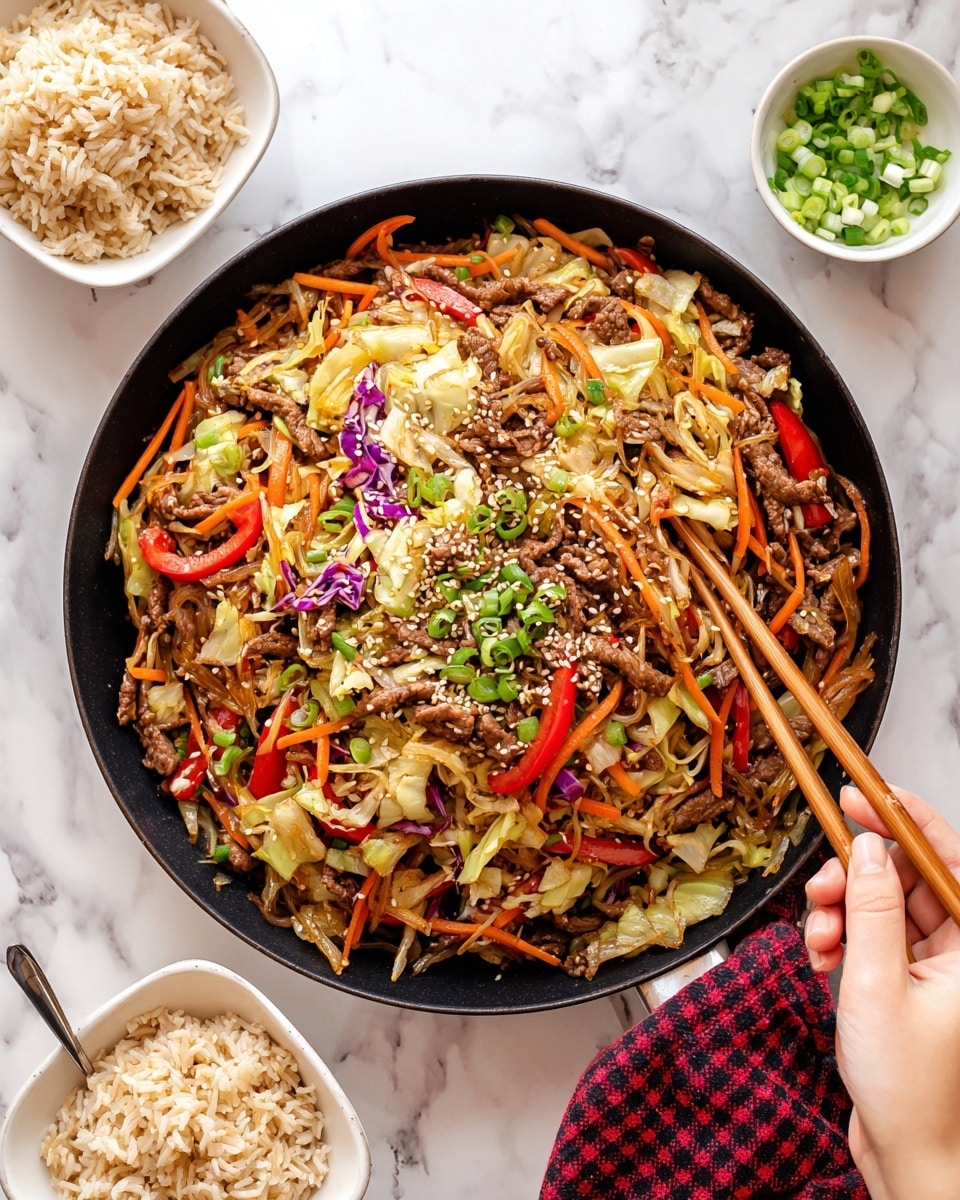 The image shows a large black pan filled with a colorful stir-fry dish made of thin slices of brown beef, julienned orange carrots, green and white chopped scallions, red bell pepper strips, and light-colored cabbage strips, all mixed together and sprinkled with white sesame seeds. Around the pan there are three small white square bowls filled with light brown cooked rice, each with a pair of light-colored wooden chopsticks resting on the bowls. A small white bowl on the top right has extra chopped green scallions, and everything is placed on a white marbled surface with a red and white checkered cloth partially visible on the bottom left corner. photo taken with an iphone --ar 4:5 --v 7