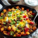 Cowboy Potatoes with Roasted Vegetables, Spiced Pork, and Melted Cheddar Recipe