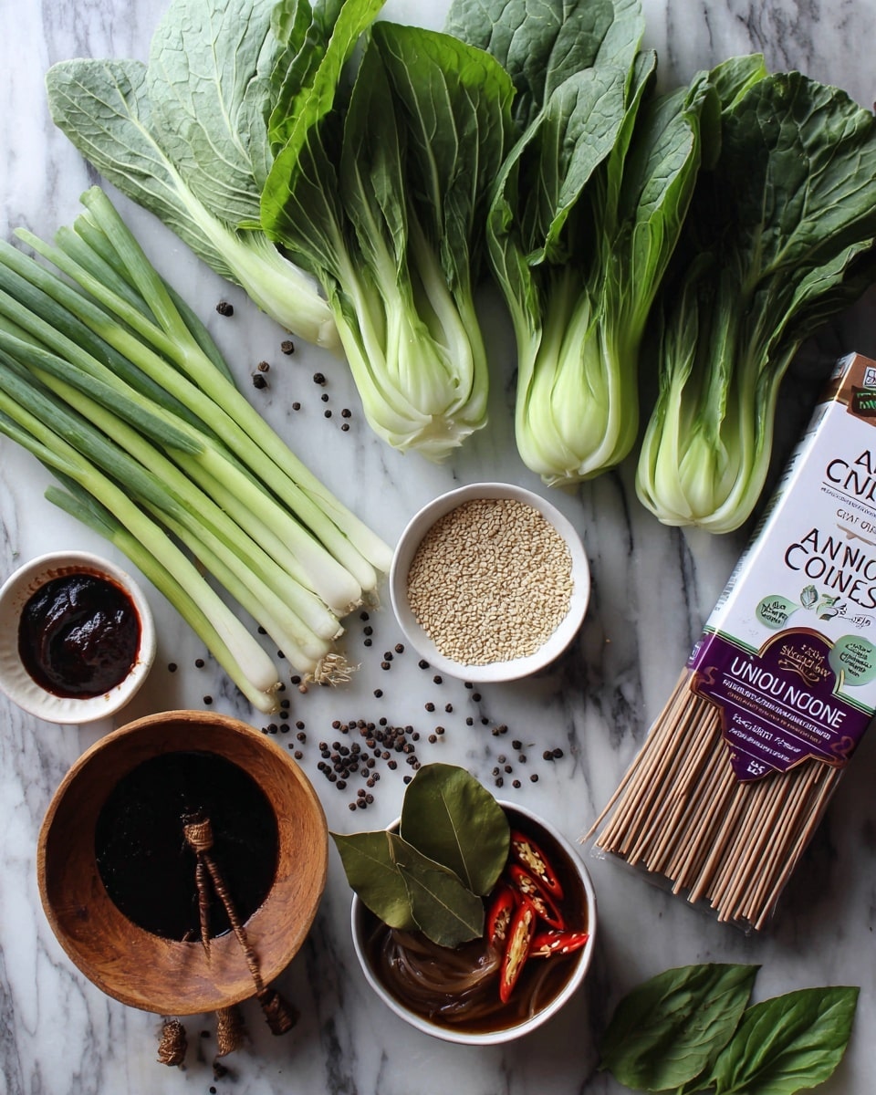 The image shows a white marble surface with various food ingredients arranged neatly on it. There is a bundle of fresh green bok choy leaves on the top right, a small white bowl with dark red sauce in the bottom left, and a wooden bowl filled with light brown sesame seeds just above it. Next to the sesame seeds, there are a few long green onions placed horizontally. Near the center, there is a white bowl with a brown broth containing sliced chili peppers and bay leaves. On the right side, there is a white package of Annie Chun's Organic Udon Noodles with purple and brown labeling. Small black peppercorns and a few green leaves are sprinkled around the bowls. The photo taken with an iphone --ar 4:5 --v 7